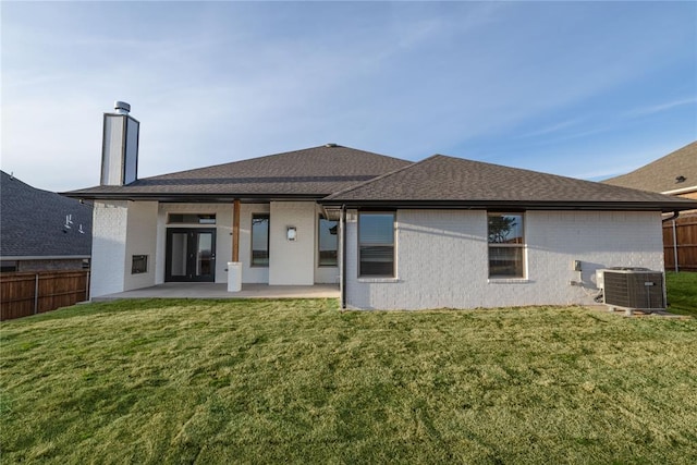 back of house with fence, cooling unit, a patio, and a lawn