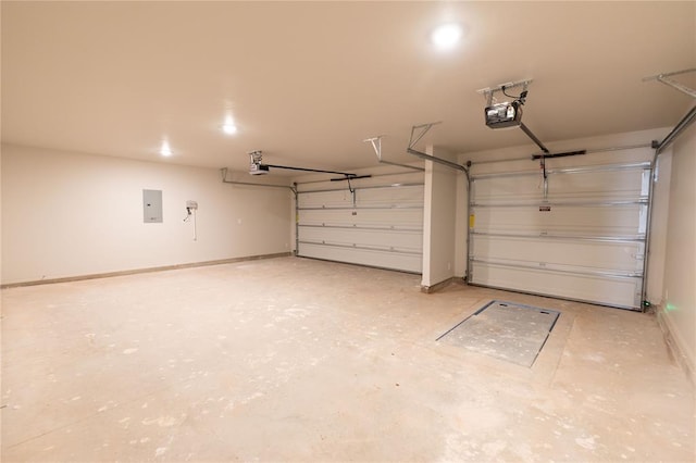 garage with a garage door opener and electric panel