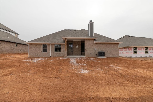 rear view of house featuring cooling unit