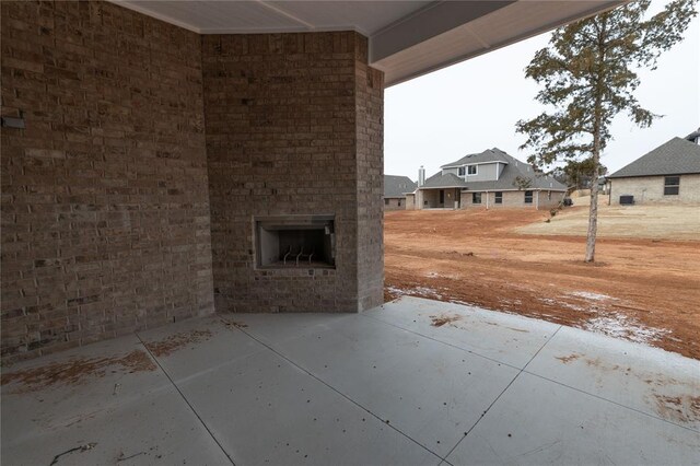 view of patio / terrace with an outdoor brick fireplace