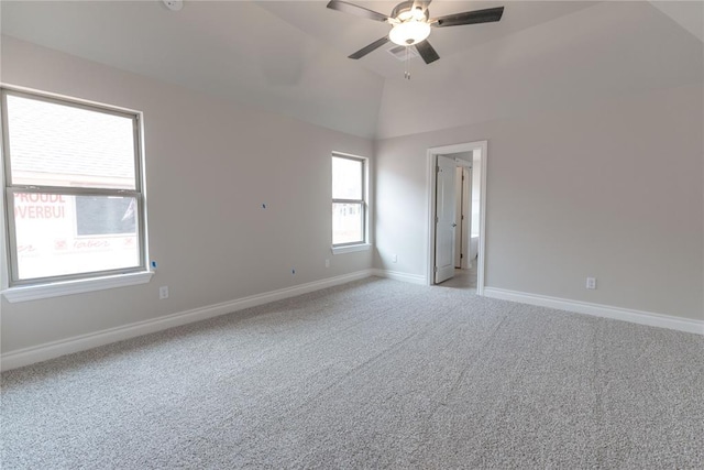 carpeted empty room with ceiling fan and lofted ceiling