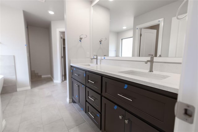 bathroom featuring vanity, a bathing tub, and tile patterned flooring