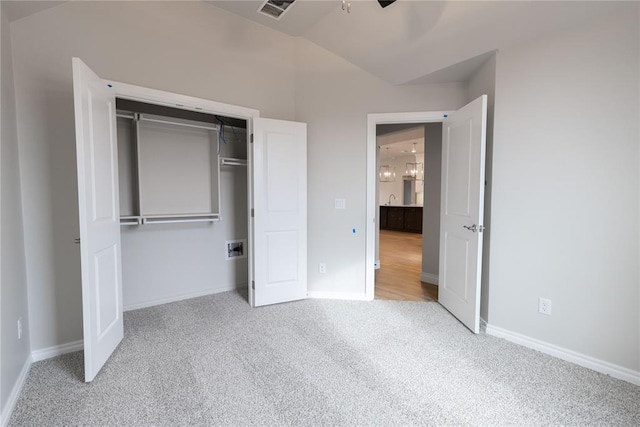 unfurnished bedroom featuring light carpet, a closet, sink, and ceiling fan