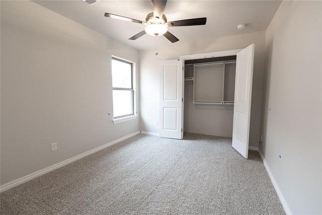 unfurnished bedroom with ceiling fan, a closet, and carpet flooring