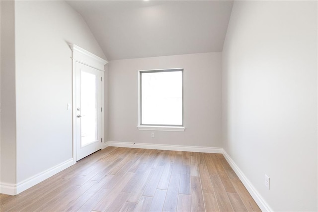 8709 Tyrion Dr, Edmond, OK 73007 - unfurnished room with vaulted ceiling, light wood-style flooring, and baseboards