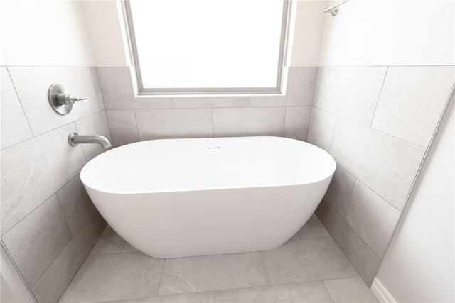8709 Tyrion Dr, Edmond, OK 73007 - full bathroom featuring tile patterned flooring, tile walls, and a freestanding bath