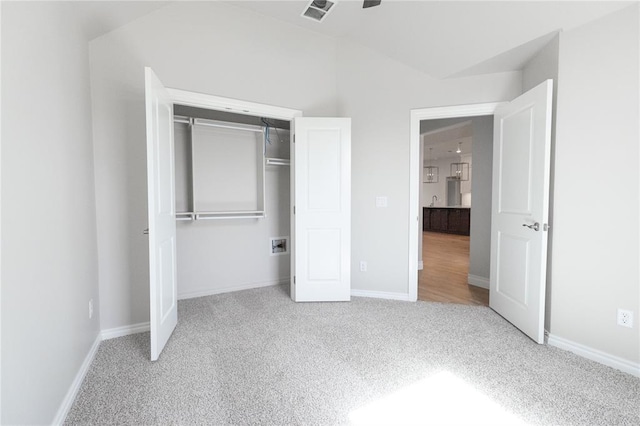 8709 Tyrion Dr, Edmond, OK 73007 - unfurnished bedroom with visible vents, lofted ceiling, a closet, carpet, and baseboards