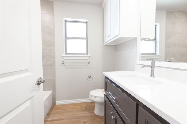 8709 Tyrion Dr, Edmond, OK 73007 - full bathroom with plenty of natural light, toilet, vanity, and wood finished floors