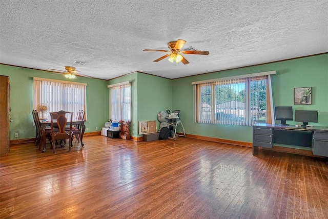 misc room with a textured ceiling, hardwood / wood-style flooring, and ceiling fan