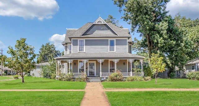 victorian home featuring a front lawn and a porch