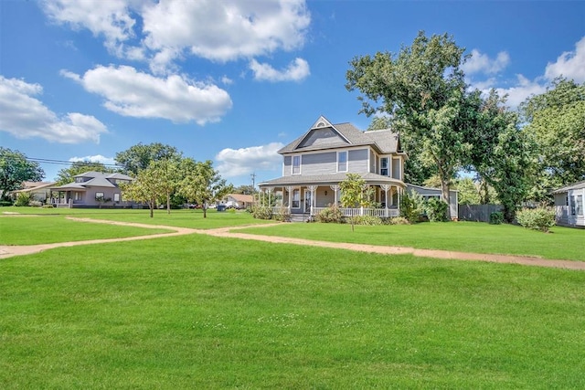 victorian house with covered porch and a front lawn