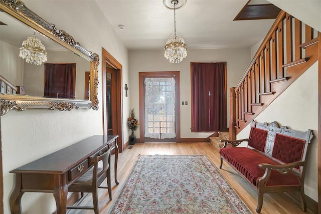 entrance foyer with a chandelier and light hardwood / wood-style flooring