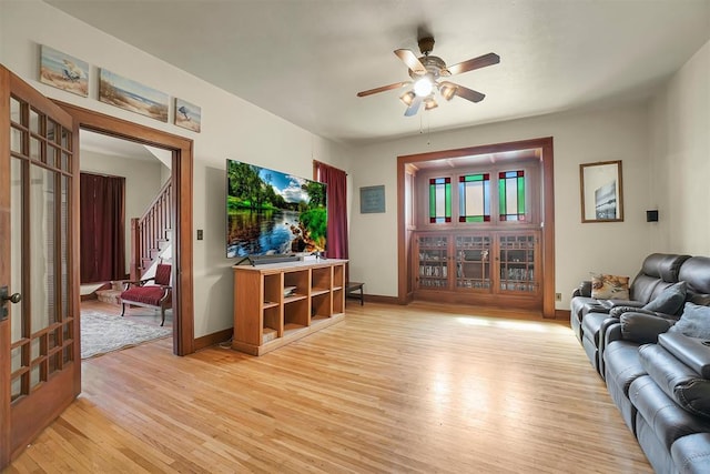 living room with ceiling fan and light wood-type flooring