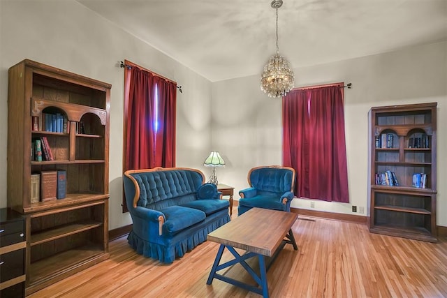 sitting room with light hardwood / wood-style floors and a notable chandelier