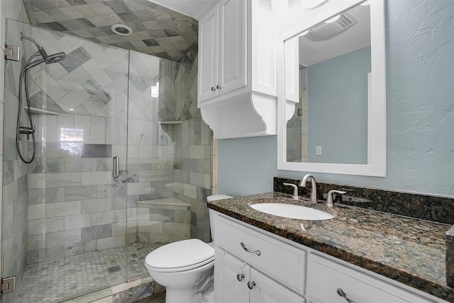 bathroom with vanity, toilet, and a shower with door