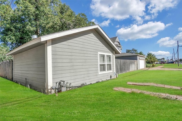 view of home's exterior featuring a garage and a yard