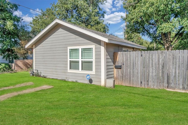 view of side of property featuring a yard