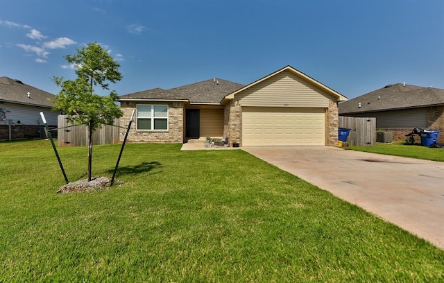 single story home with a garage, a front lawn, and central air condition unit