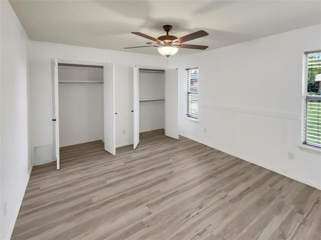 unfurnished bedroom featuring light wood-type flooring and ceiling fan