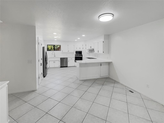 kitchen featuring white cabinetry, sink, stainless steel appliances, kitchen peninsula, and light tile patterned flooring