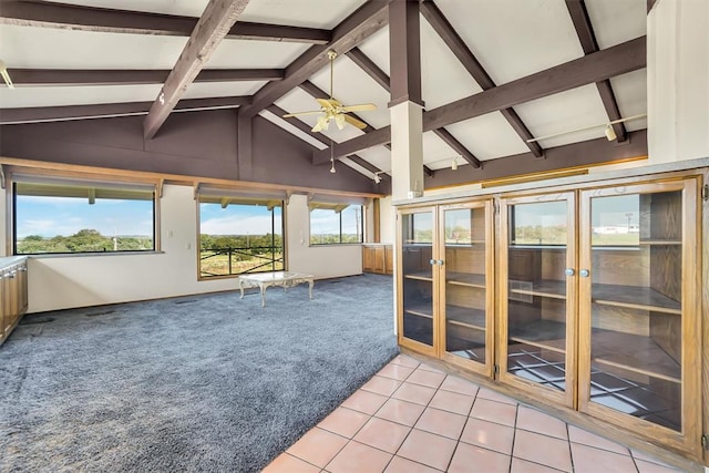 unfurnished sunroom with french doors, vaulted ceiling with beams, and ceiling fan