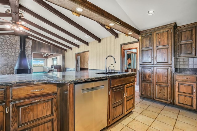 103 Park Dr, Sayre, OK 73662 - kitchen featuring dishwasher, light tile patterned flooring, a wood stove, a ceiling fan, and dark stone counters