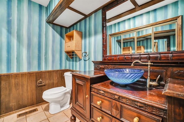 103 Park Dr, Sayre, OK 73662 - bathroom with wallpapered walls, a wainscoted wall, tile patterned flooring, and vanity