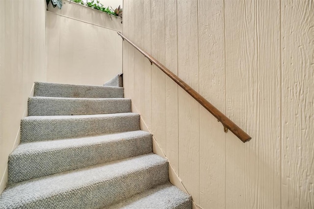 stairway with wood walls