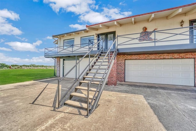 view of front of home with a balcony and a garage