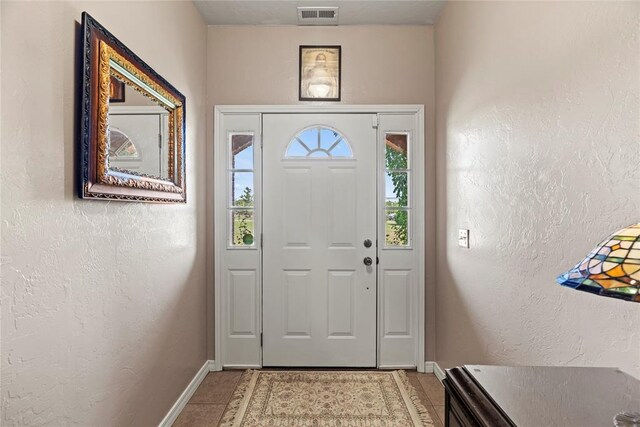 doorway to outside featuring light tile patterned floors