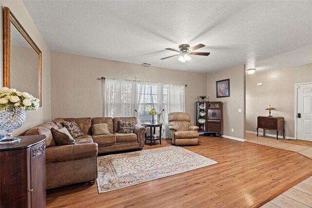 living room with ceiling fan and light wood-type flooring