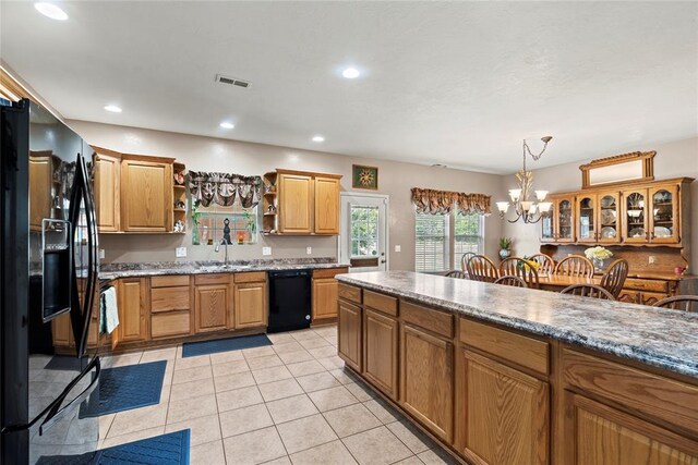 kitchen with sink, a notable chandelier, decorative light fixtures, light tile patterned flooring, and black appliances