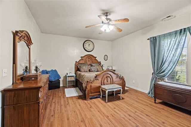 bedroom with light hardwood / wood-style flooring and ceiling fan