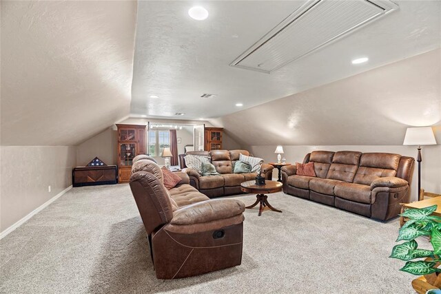 living room featuring carpet flooring, a textured ceiling, and lofted ceiling