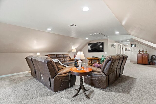 home theater room with light colored carpet and vaulted ceiling