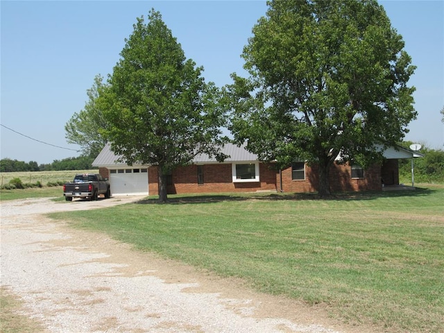 view of front of home featuring a garage and a front lawn