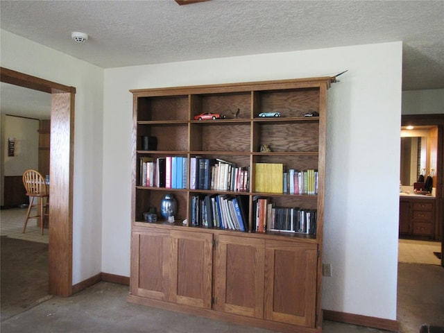 interior details with carpet flooring and a textured ceiling