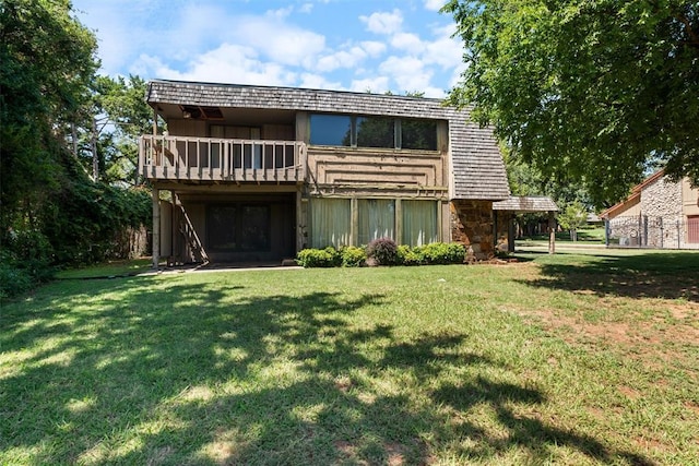 2940 Browne Stone Rd, Oklahoma City, OK 73120 - rear view of house featuring stone siding, a lawn, a deck, and mansard roof