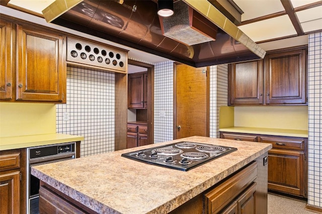 kitchen with black electric cooktop and a center island