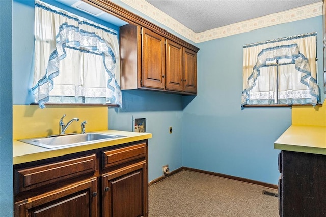 laundry area featuring sink, electric dryer hookup, cabinets, a textured ceiling, and light colored carpet