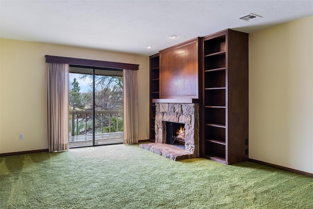 unfurnished living room with carpet floors and a fireplace