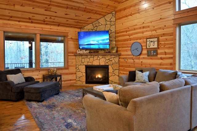 living room with a wealth of natural light, wood-type flooring, vaulted ceiling, and wooden ceiling