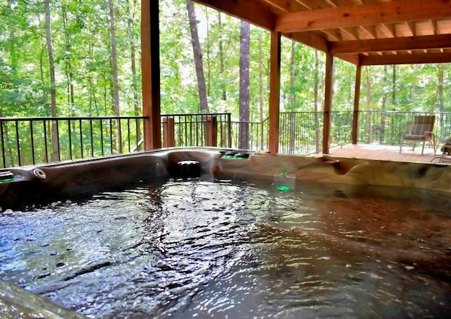 wooden terrace featuring a hot tub