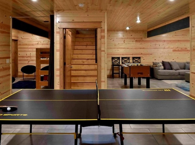 rec room with tile patterned floors, wooden walls, and wooden ceiling