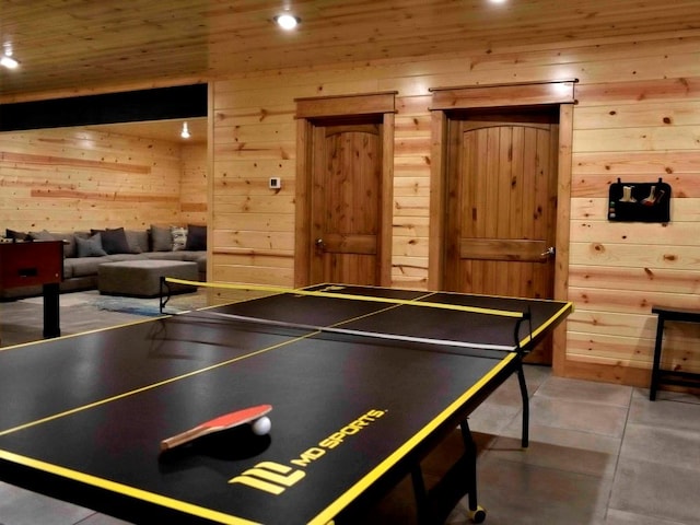 game room with tile patterned flooring, wooden walls, and wood ceiling