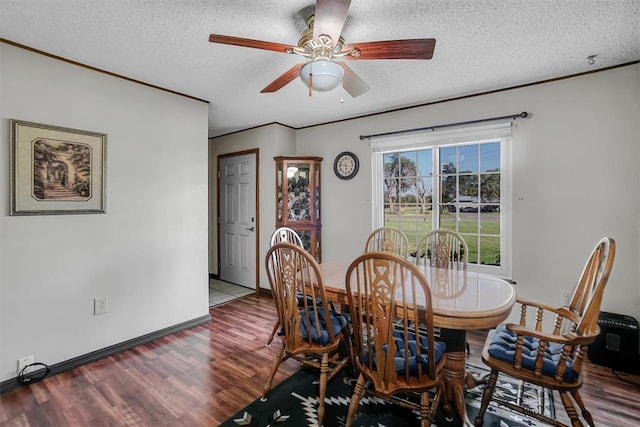 dining space featuring ceiling fan, hardwood / wood-style floors, and a textured ceiling