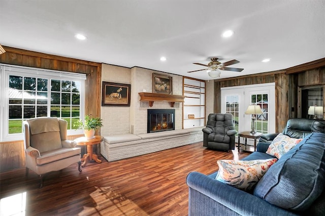 living room featuring a fireplace, a healthy amount of sunlight, and hardwood / wood-style flooring