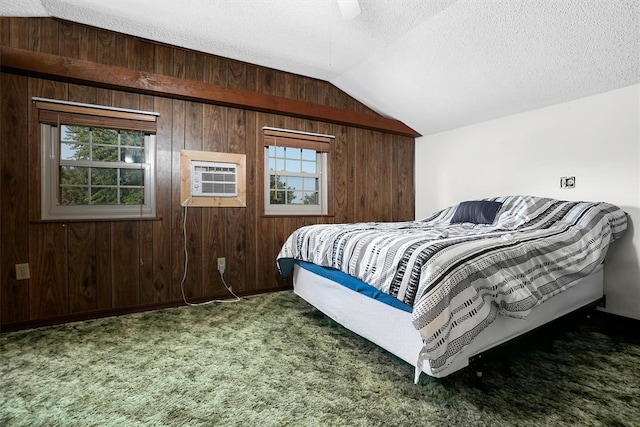 bedroom with dark colored carpet, multiple windows, and wooden walls