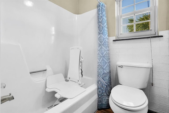 bathroom featuring toilet, tile walls, and shower / tub combo with curtain