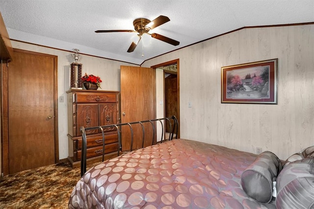 bedroom with ceiling fan, carpet floors, and a textured ceiling